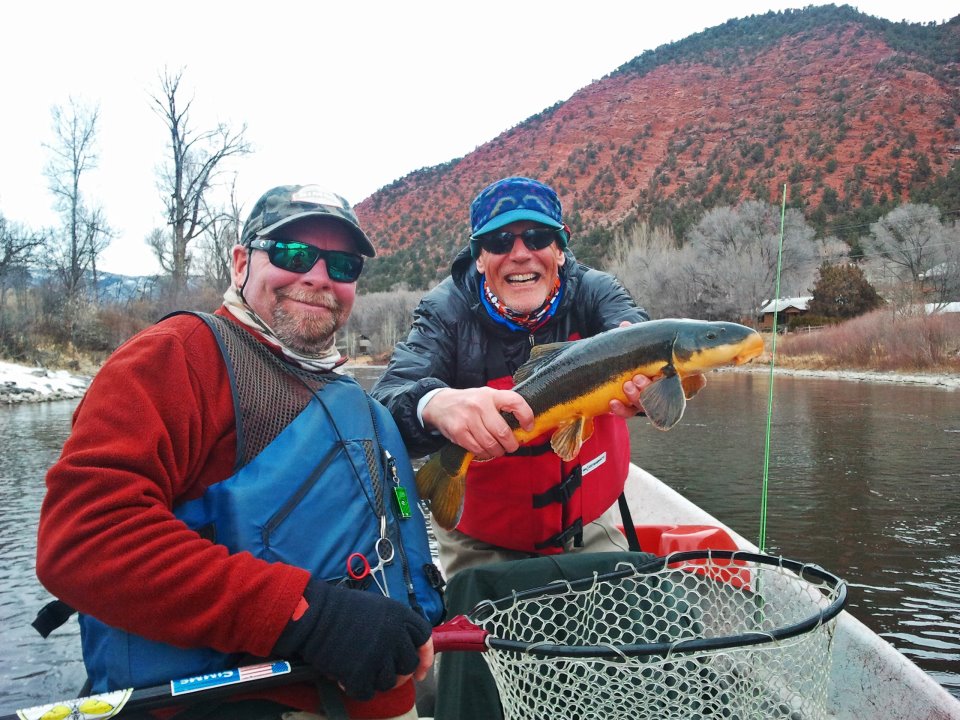 Angler with flannelmouth sucker on Roaring Fork River, Colorado